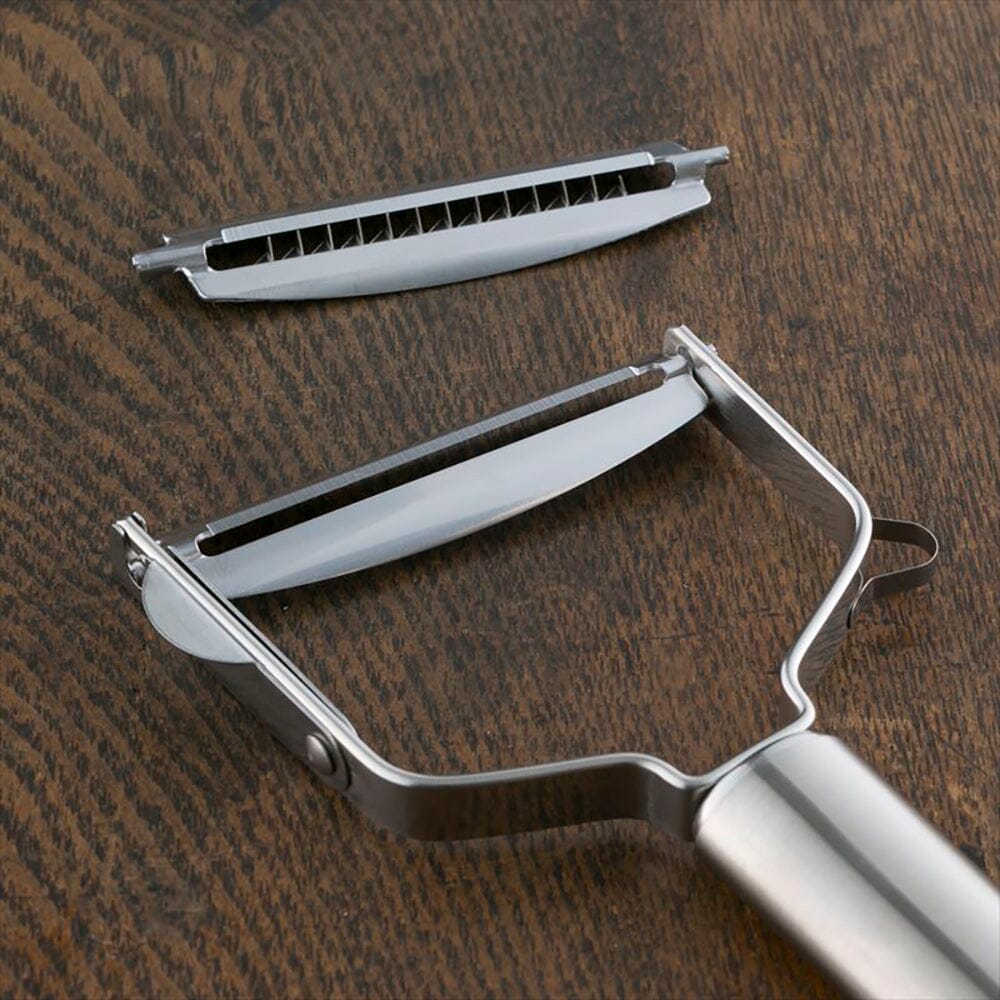 Metal vegetable peeler on a wooden surface