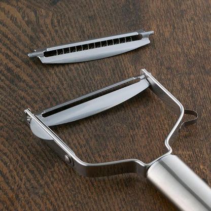 Metal vegetable peeler on a wooden surface