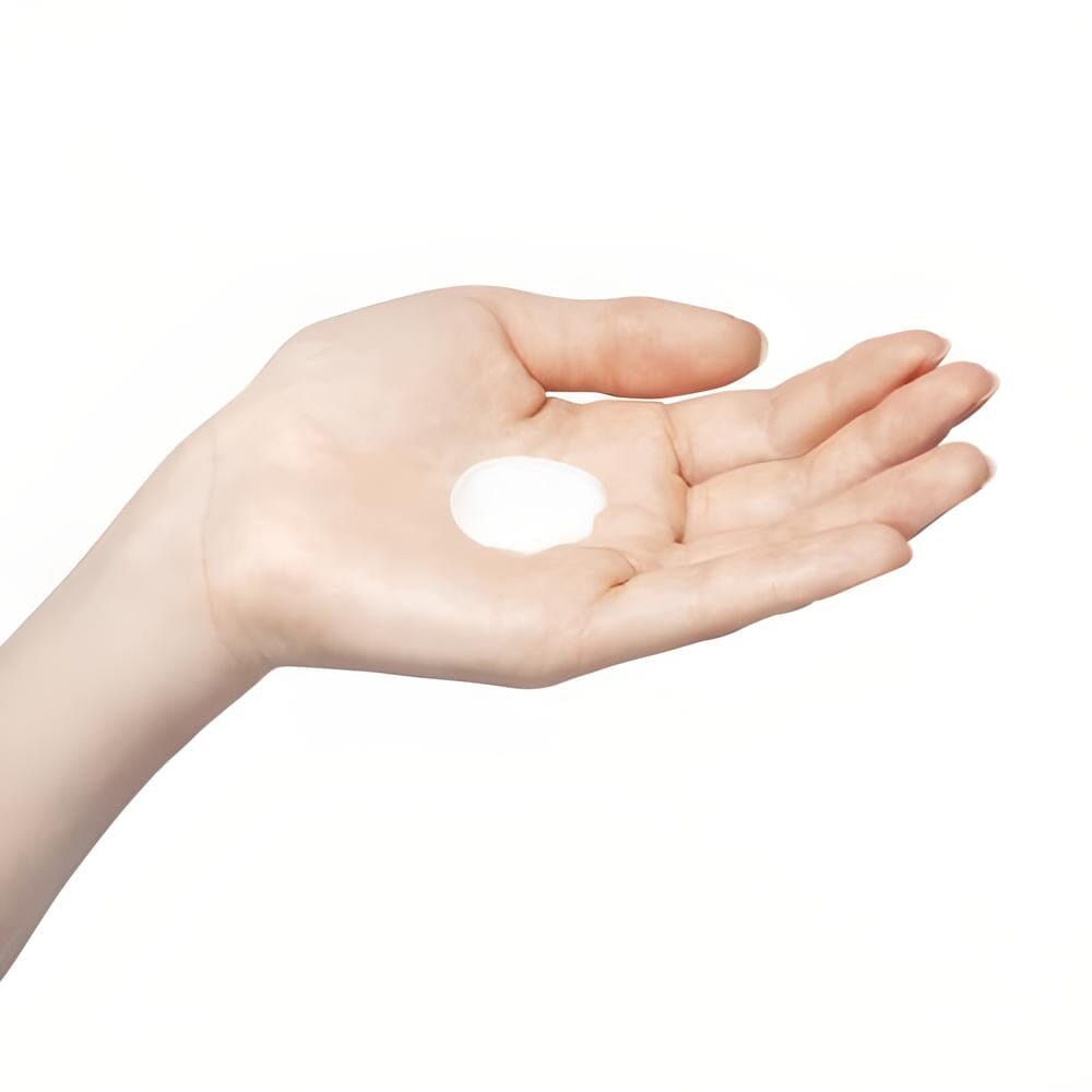 Milky lotion on hand